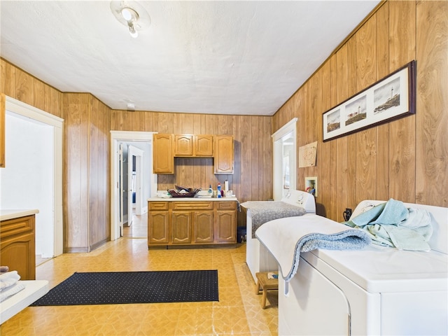 washroom with wood walls and light flooring