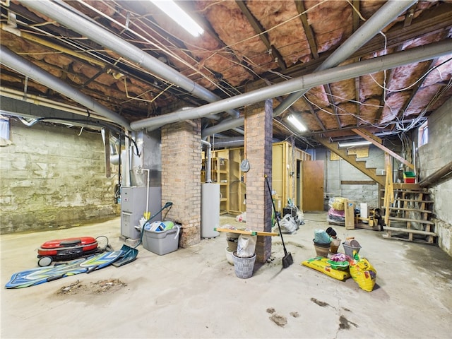 unfinished below grade area featuring gas water heater, heating unit, and stairs