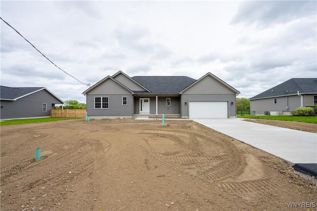 2536 Beverly Dr, Eden, NY 14057 - view of front of house with concrete driveway, a garage, and fence