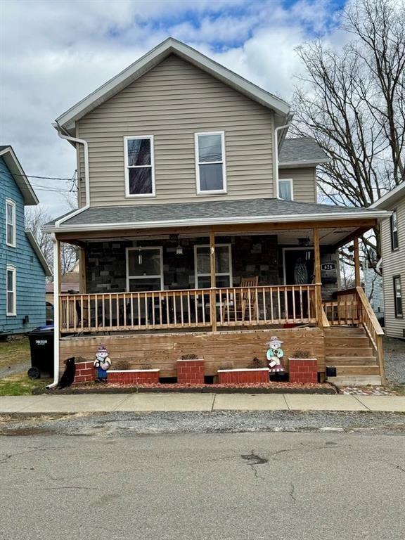 426 Loder St, Barton, NY 14892 - view of front facade with covered porch, roof with shingles, and stone siding