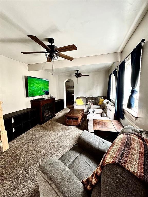 426 Loder St, Barton, NY 14892 - living room with ceiling fan, arched walkways, and a fireplace
