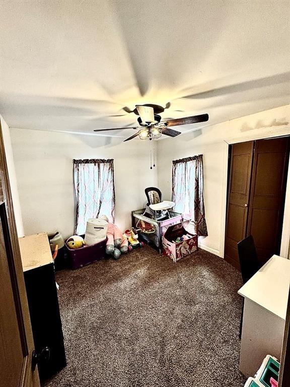 426 Loder St, Barton, NY 14892 - bedroom with dark colored carpet, a ceiling fan, and a textured ceiling