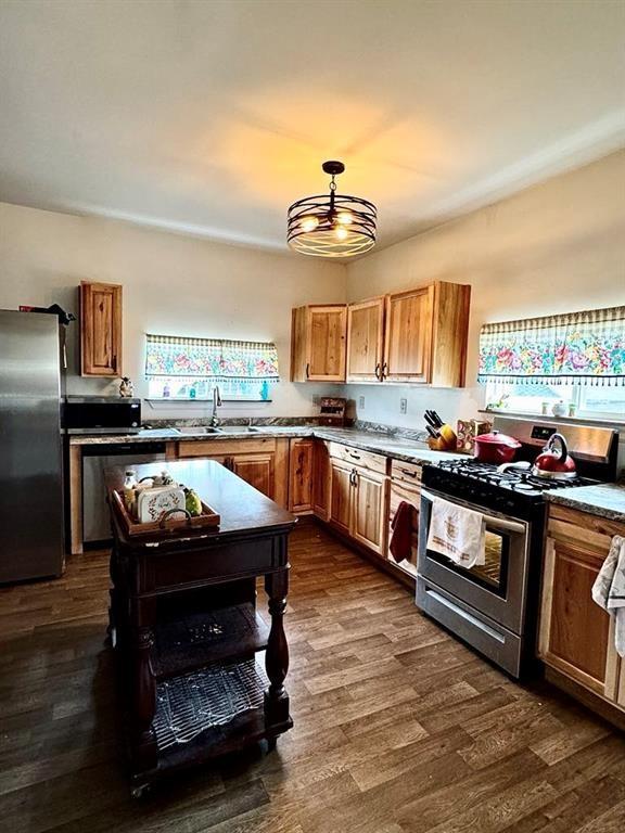 426 Loder St, Barton, NY 14892 - kitchen with stainless steel appliances, a sink, dark wood-style flooring, and brown cabinets