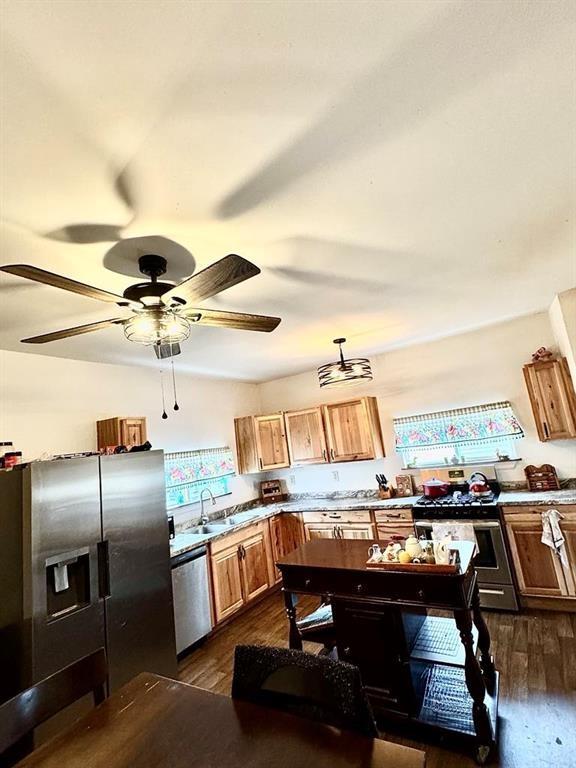 426 Loder St, Barton, NY 14892 - kitchen featuring stainless steel appliances, dark wood-style flooring, a sink, and a ceiling fan