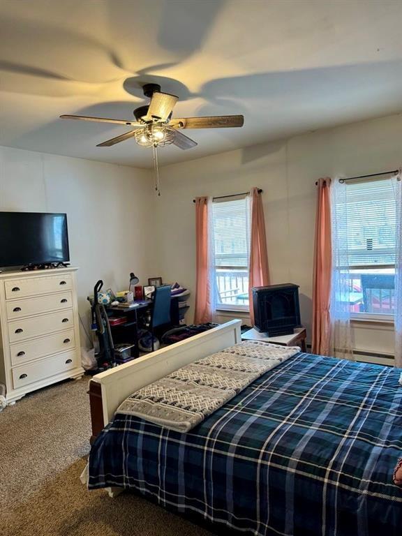 426 Loder St, Barton, NY 14892 - bedroom with carpet flooring, a baseboard radiator, and ceiling fan