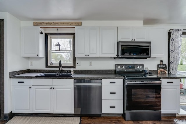 36852 Middle Rd, Orleans, NY 13656 - kitchen featuring appliances with stainless steel finishes, a sink, dark countertops, and white cabinetry