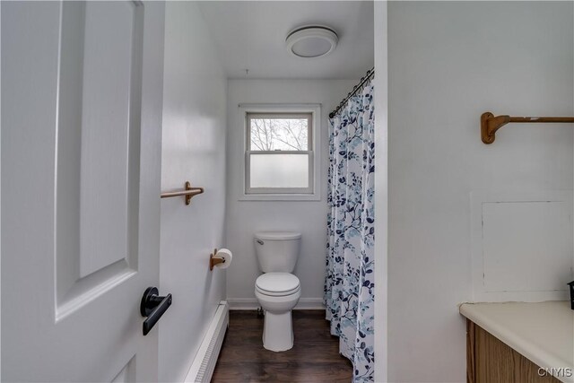 36852 Middle Rd, Orleans, NY 13656 - bathroom with a baseboard radiator, wood finished floors, toilet, baseboards, and a shower with shower curtain