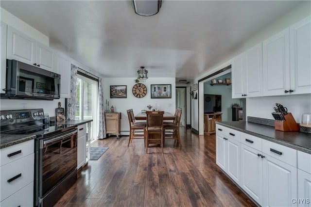 36852 Middle Rd, Orleans, NY 13656 - kitchen with appliances with stainless steel finishes, dark countertops, dark wood-style flooring, and white cabinetry