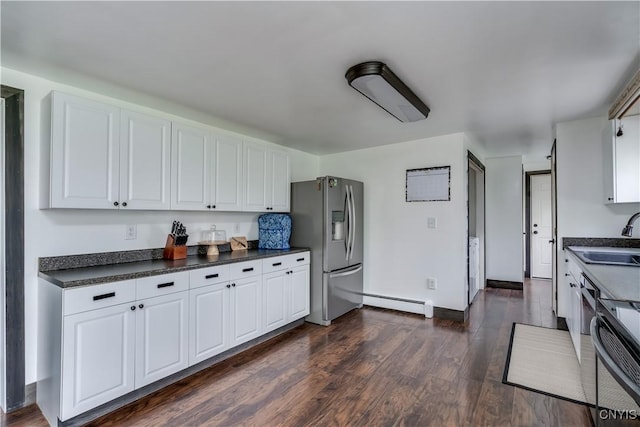 36852 Middle Rd, Orleans, NY 13656 - kitchen featuring stainless steel refrigerator with ice dispenser, a baseboard heating unit, a sink, dark countertops, and white cabinetry