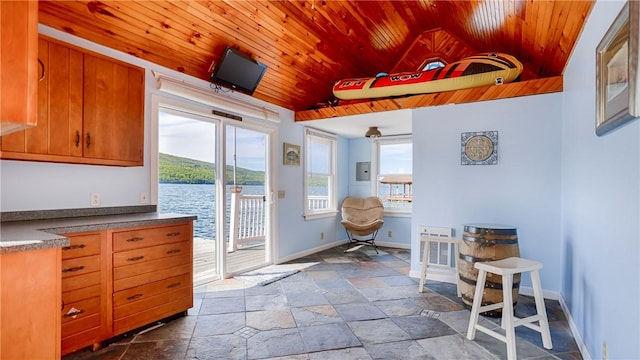 1267 S Lake Rd, Middlesex, NY 14507 - kitchen with wood ceiling, stone tile flooring, baseboards, brown cabinets, and lofted ceiling