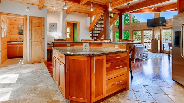 1267 S Lake Rd, Middlesex, NY 14507 - kitchen with wooden ceiling, beam ceiling, open floor plan, stainless steel refrigerator with ice dispenser, and stone tile floors