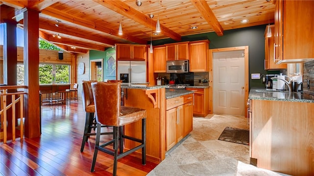 1267 S Lake Rd, Middlesex, NY 14507 - kitchen with stainless steel appliances, wood ceiling, decorative backsplash, dark stone counters, and a breakfast bar area