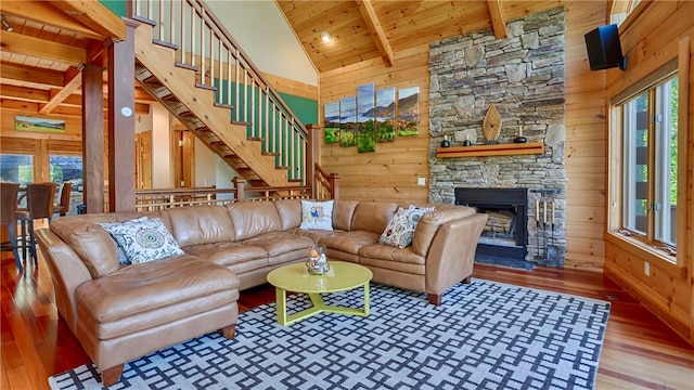 1267 S Lake Rd, Middlesex, NY 14507 - living area featuring wooden ceiling, wood finished floors, wood walls, a stone fireplace, and beam ceiling