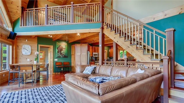 1267 S Lake Rd, Middlesex, NY 14507 - living area featuring a towering ceiling, stairs, wood finished floors, and wood walls