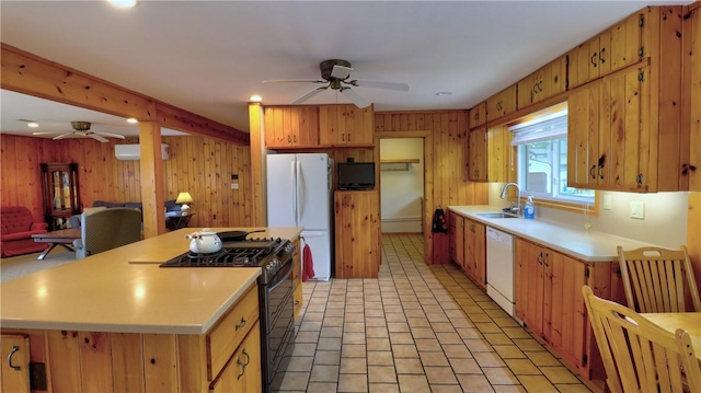 kitchen featuring a ceiling fan, white appliances, a sink, light countertops, and open floor plan