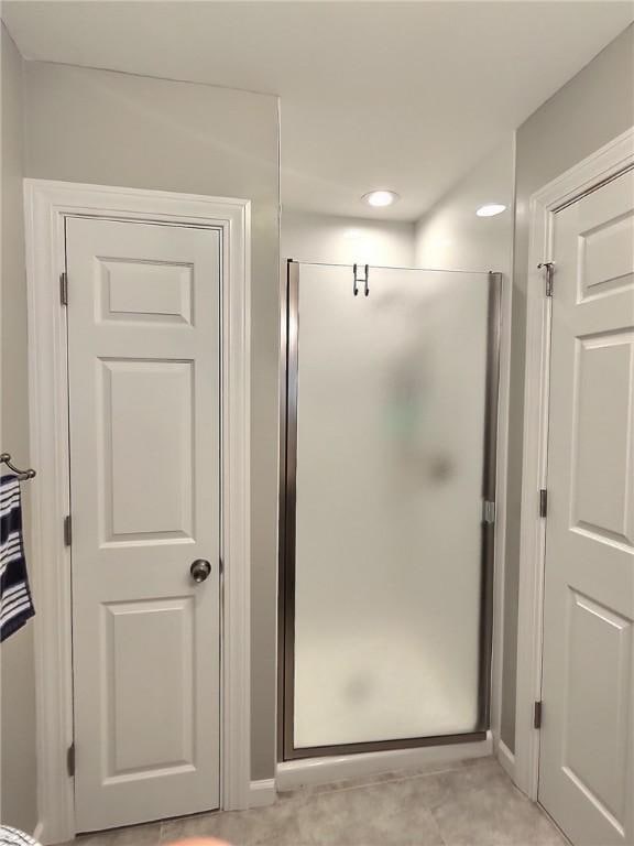 bathroom with a shower stall and recessed lighting