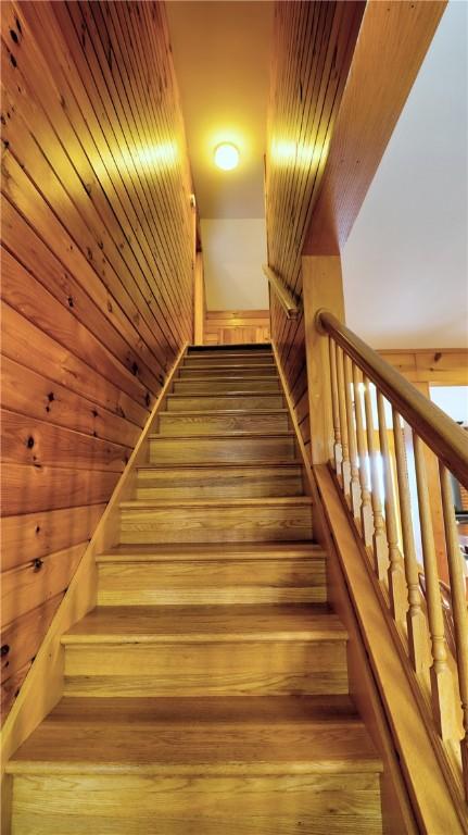 stairs featuring hardwood / wood-style flooring