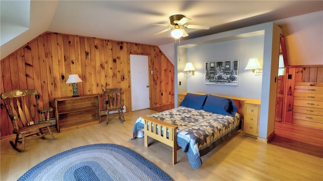 bedroom with wood finished floors, wooden walls, and a ceiling fan