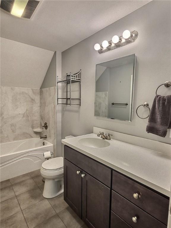 full bathroom with toilet, vanity, tile patterned floors, bathtub / shower combination, and vaulted ceiling