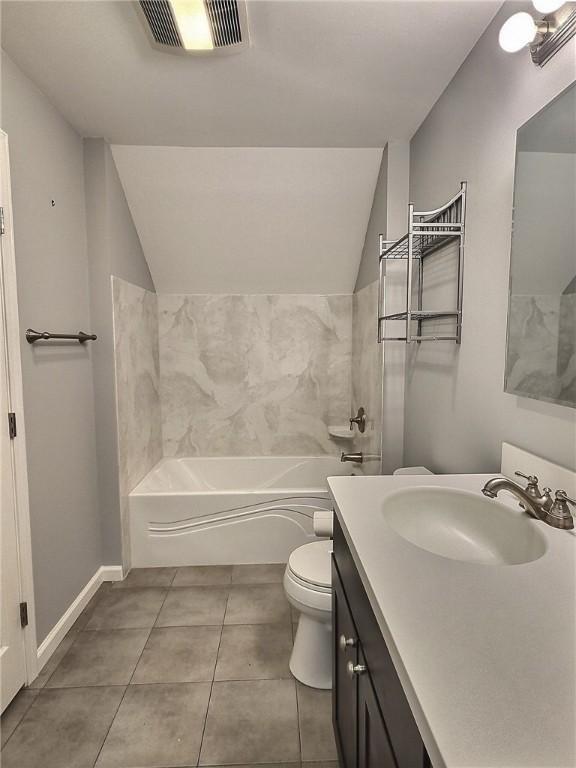 full bath with lofted ceiling, toilet, tile patterned floors, vanity, and baseboards