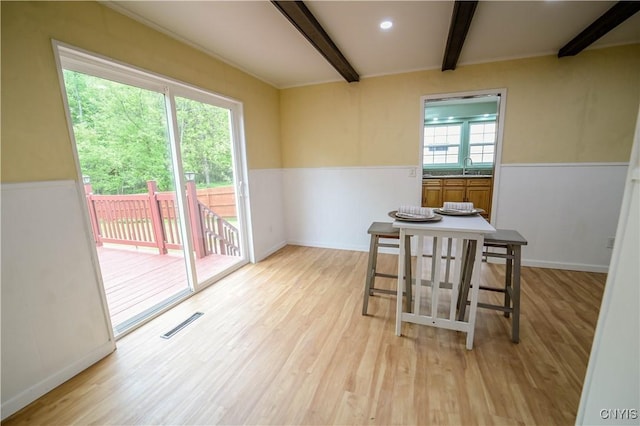 11 White St, Kirkland, NY 13323 - dining area with beam ceiling, light wood-style floors, and a wainscoted wall