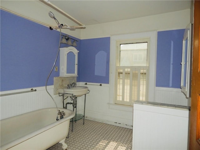 7 Walnut St, Oneonta-City, NY 13820 - bathroom with a wainscoted wall, a freestanding bath, and tile patterned flooring