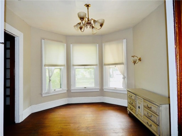 7 Walnut St, Oneonta-City, NY 13820 - unfurnished dining area with a chandelier, healthy amount of natural light, and dark wood-style floors