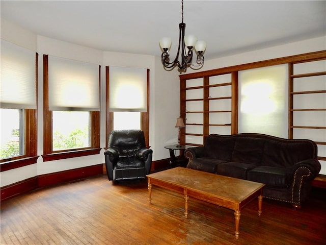 7 Walnut St, Oneonta-City, NY 13820 - living area with a chandelier, hardwood / wood-style floors, and baseboards