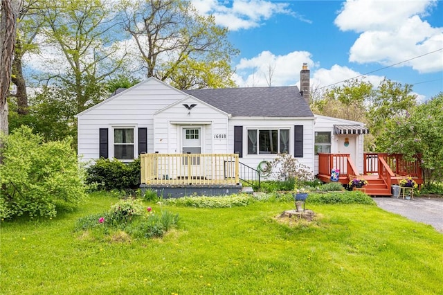 16818 Ridge Rd, Murray, NY 14470 - bungalow-style home featuring a chimney, a front yard, and a deck