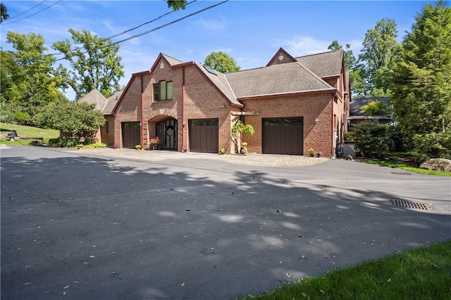 4331 Tichenor Point Dr, Canandaigua-Town, NY 14424 - view of front of home featuring brick siding, an attached garage, driveway, and roof with shingles