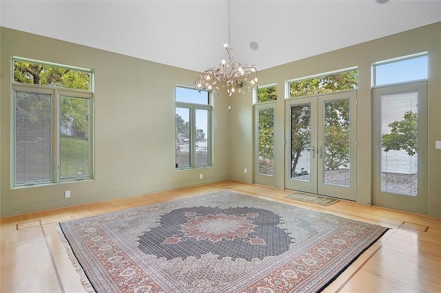 4331 Tichenor Point Dr, Canandaigua-Town, NY 14424 - empty room featuring french doors, a chandelier, and wood finished floors