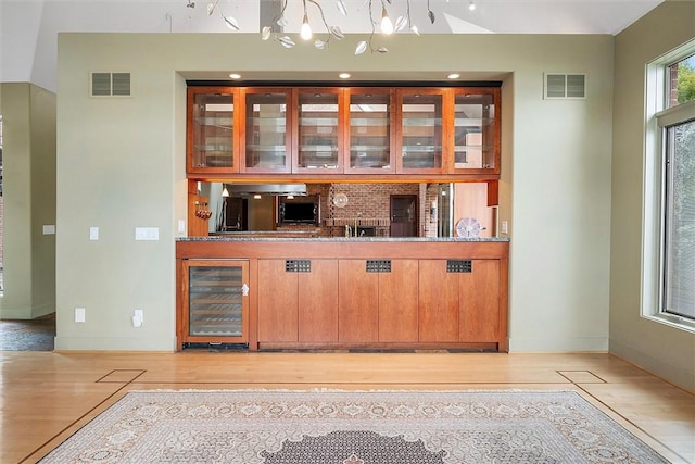 4331 Tichenor Point Dr, Canandaigua-Town, NY 14424 - bar with beverage cooler, light wood-style flooring, and baseboards