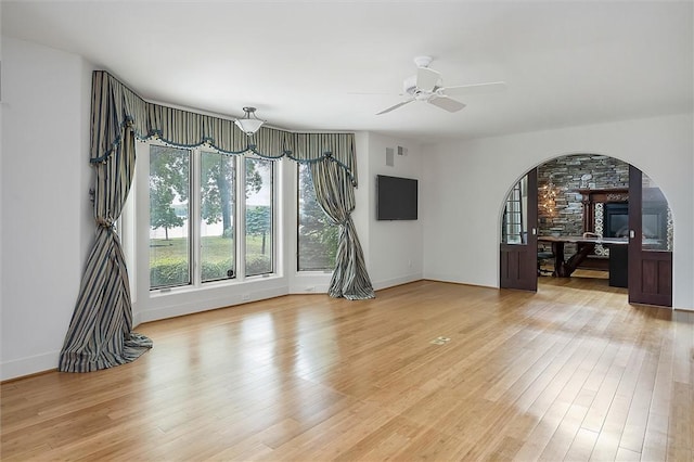 4331 Tichenor Point Dr, Canandaigua-Town, NY 14424 - spare room with a ceiling fan, arched walkways, light wood-type flooring, and baseboards