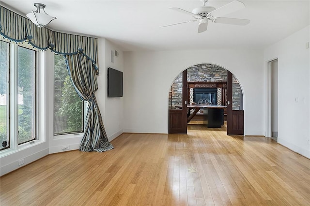 4331 Tichenor Point Dr, Canandaigua-Town, NY 14424 - spare room with light wood-style floors, baseboards, ceiling fan, and arched walkways