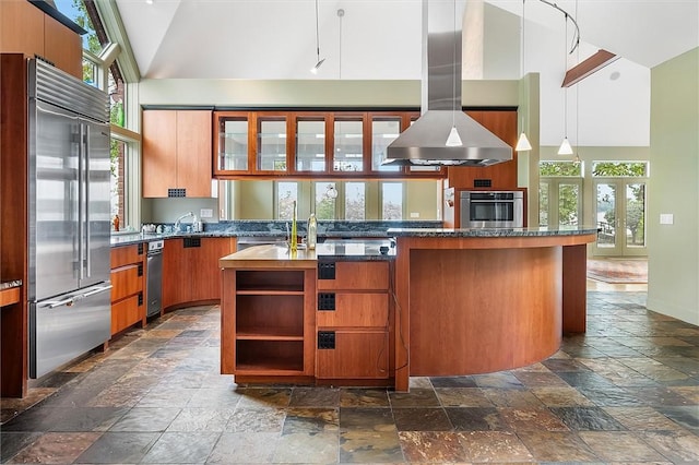 4331 Tichenor Point Dr, Canandaigua-Town, NY 14424 - kitchen featuring appliances with stainless steel finishes, stone tile flooring, high vaulted ceiling, island exhaust hood, and healthy amount of natural light
