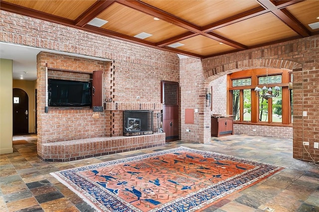 4331 Tichenor Point Dr, Canandaigua-Town, NY 14424 - living room featuring arched walkways, stone tile flooring, coffered ceiling, beamed ceiling, and a fireplace
