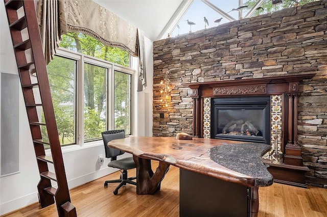 4331 Tichenor Point Dr, Canandaigua-Town, NY 14424 - home office featuring baseboards, vaulted ceiling, wood finished floors, and a glass covered fireplace