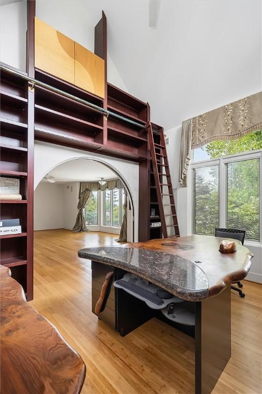 4331 Tichenor Point Dr, Canandaigua-Town, NY 14424 - dining space with light wood-style flooring, stairs, arched walkways, and a high ceiling