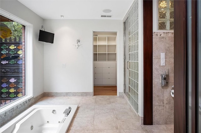 4331 Tichenor Point Dr, Canandaigua-Town, NY 14424 - full bathroom with a spacious closet, tile patterned floors, and a tub with jets