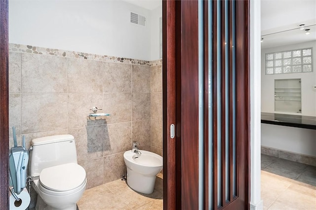 4331 Tichenor Point Dr, Canandaigua-Town, NY 14424 - bathroom with a bidet, tile patterned flooring, tile walls, and toilet