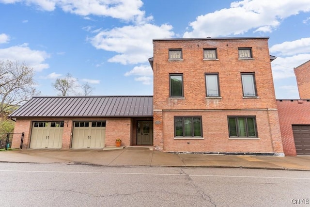 8 Mohawk St, Little Falls-City, NY 13365 - view of front of home featuring brick siding, driveway, a garage, and metal roof