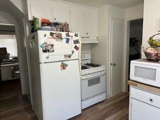 kitchen featuring white appliances, extractor fan, dark wood-type flooring, and white cabinetry