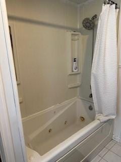 bathroom featuring tile patterned flooring and shower / tub combo with curtain