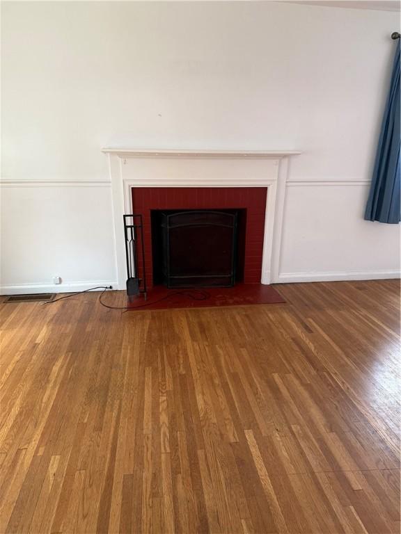 167 Rogers Pkwy, Irondequoit, NY 14617 - detailed view of wood finished floors, a fireplace with flush hearth, and baseboards