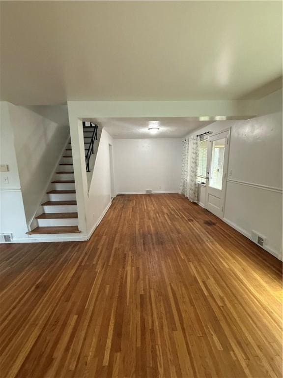 167 Rogers Pkwy, Irondequoit, NY 14617 - unfurnished living room featuring stairway, wood finished floors, and baseboards