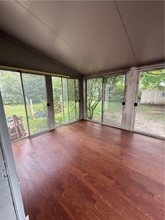 167 Rogers Pkwy, Irondequoit, NY 14617 - unfurnished sunroom featuring wood finished floors and vaulted ceiling