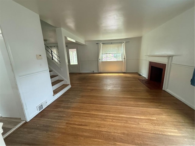 167 Rogers Pkwy, Irondequoit, NY 14617 - unfurnished living room featuring stairs, a fireplace with flush hearth, and wood finished floors