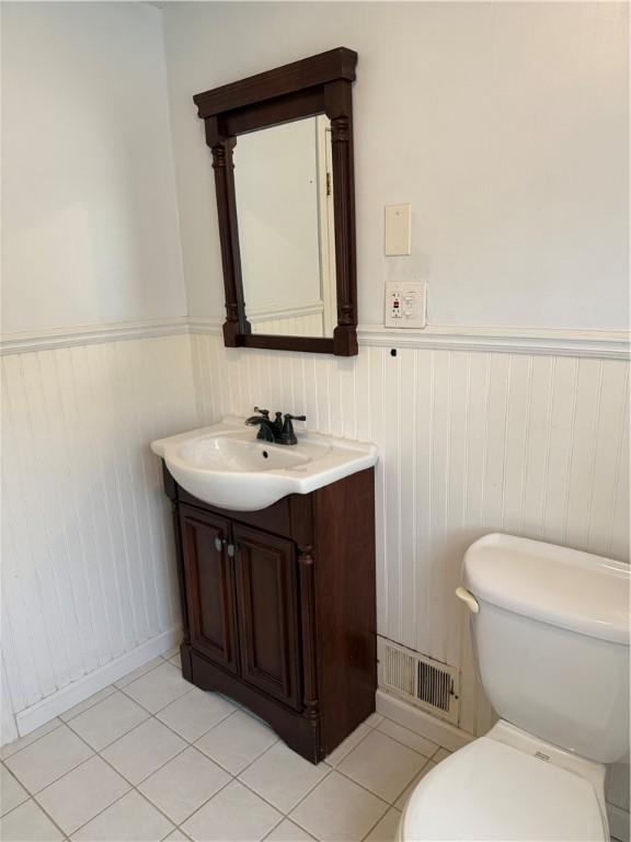 167 Rogers Pkwy, Irondequoit, NY 14617 - half bathroom with vanity, wainscoting, toilet, and tile patterned flooring