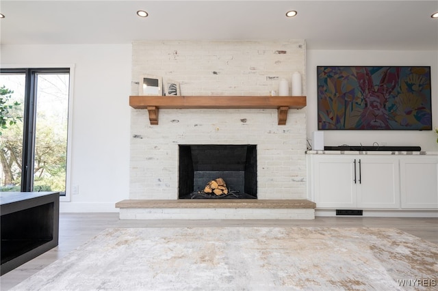 14 Wynngate Ln, Amherst, NY 14221 - unfurnished living room with recessed lighting, light wood-style floors, and a brick fireplace