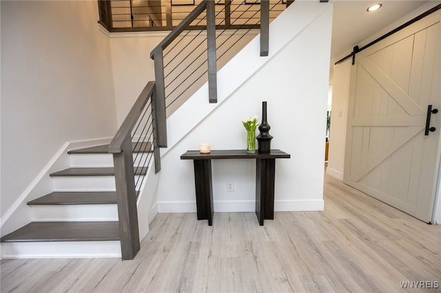 14 Wynngate Ln, Amherst, NY 14221 - staircase with wood finished floors, a barn door, and recessed lighting